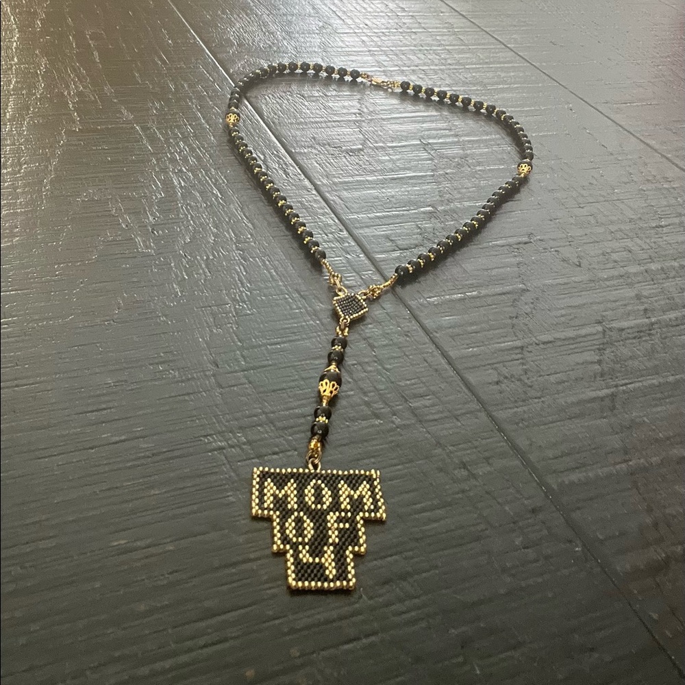 Handcrafted black and gold beaded “Mom of 4” necklace.